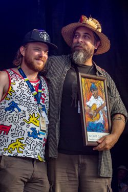  'Northern Lights Festival Boréal Executive/Artistic Director Max Merrifield, presents outgoing Artistic Director Paul Loewenberg with a token of appreciation at the 45th annual festival last July'.  photo by Leah Morise