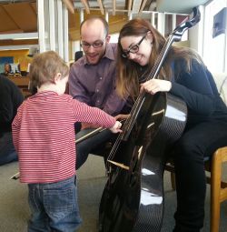 Members of the Sudbury Symphony performing for a young listener.