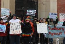 Demonstrators at the Solidarity Against Austerity action in Sudbury delivering an anti-austerity message in front of Liberal MPP Rick Bartolucci's office. (Photo by Larson Heinonen)
