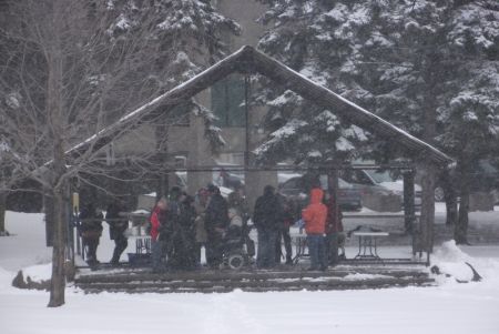 People beginning to gather in Memorial Park in downtown Sudbury for the Solidarity Agaisnt Austerity rally, meal, and march, despite the weather. (Photo by Scott Neigh)