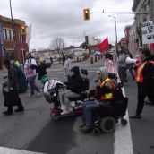 The Saturday march was lead by people with disabilities. This shows the march turning onto Elm Street from Elgin Street in downtown Sudbury. (Photo by Scott Neigh)