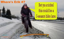 :  ‘Under each snow bank might be a bike lane in waiting.  Identify where Erik is riding on a potential boulevard bike lane, for a chance to win a mystery prize.’ Photo Credit:  Naomi Grant and Cindy O’Neil